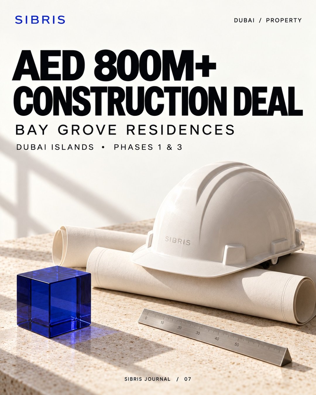 Conceptual construction still life with white hard hat, rolled papers and cobalt cube; not the Bay Grove site.